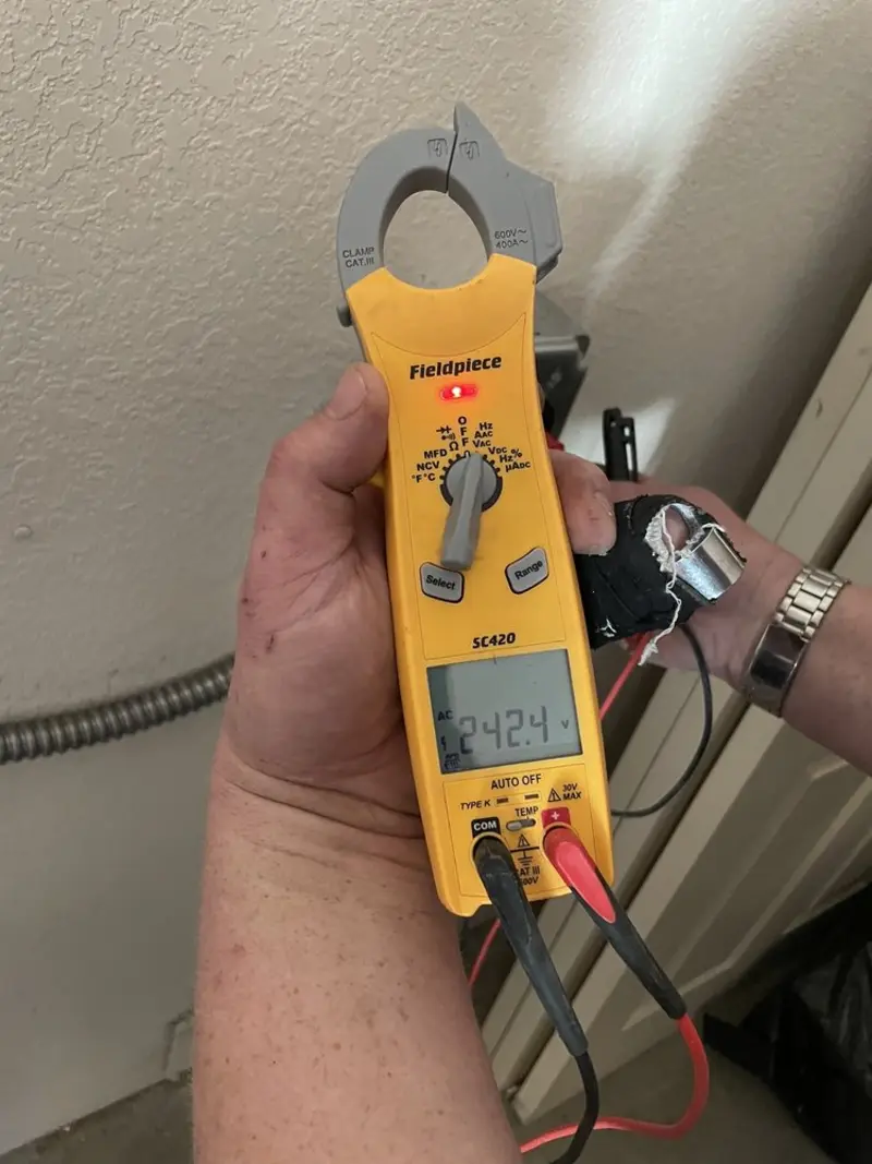 Voltage testing with clamp meter during Ceiling Fan Installation in Stockholm